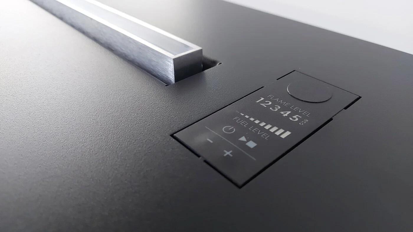 Close-up of the Denver F6 touch display on a black top plate
