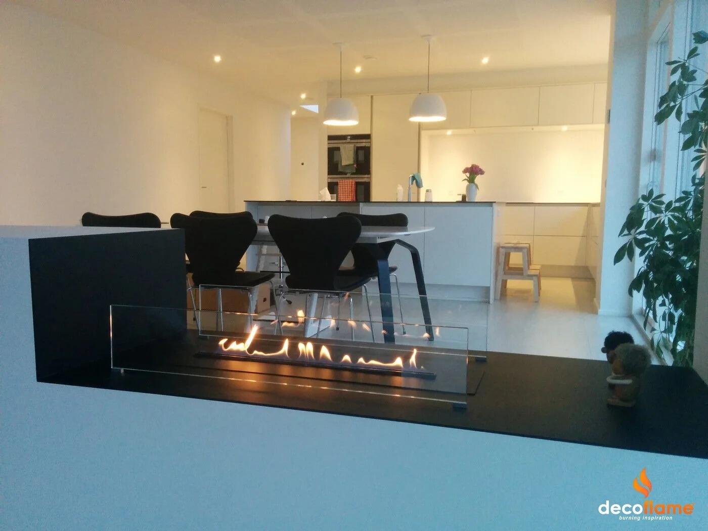Denver F3 burner in a low black fireplace forming a room divider in an open-plan home