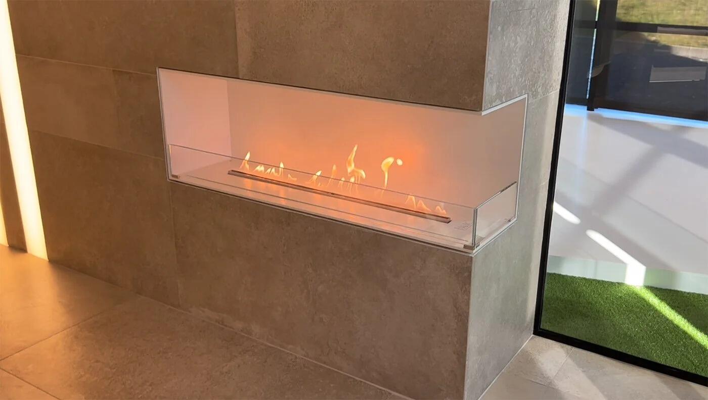 Montreal corner bio-ethanol fire with glass side in a stone-clad wall