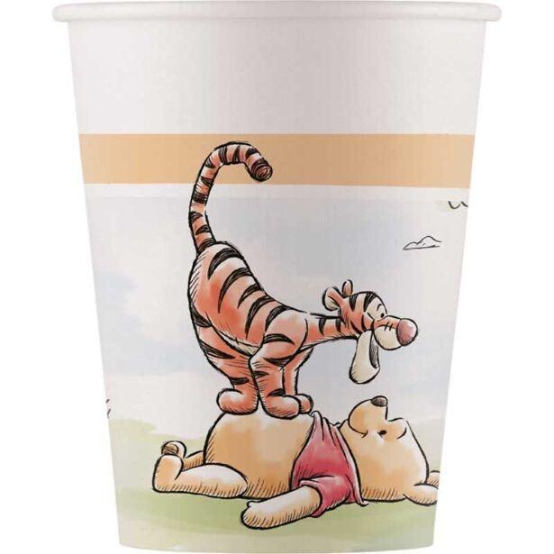 A 200m paper cup featuring Winnie the Pooh lying down on the grass with TIgger standing on Winnie's tummy