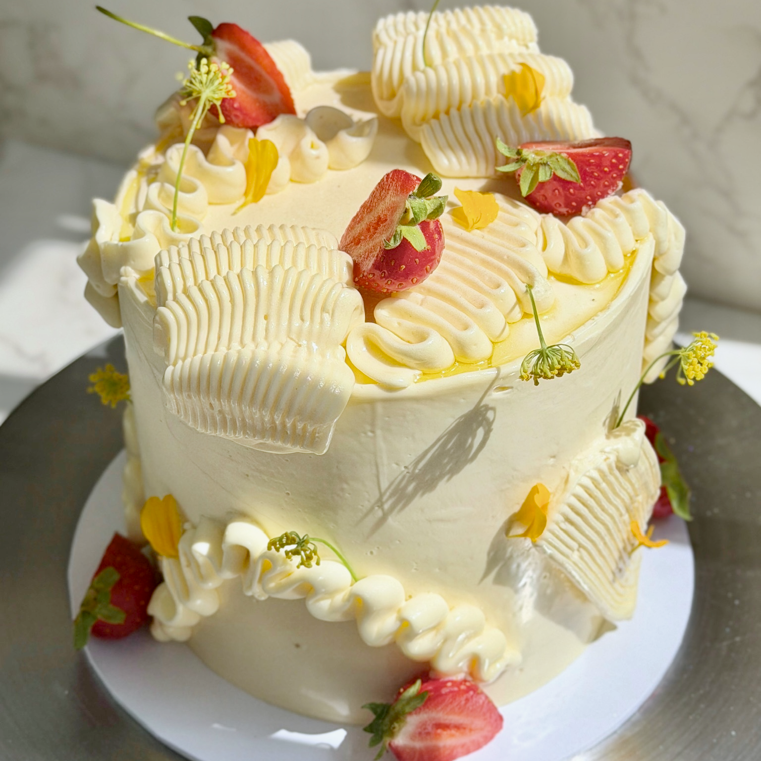 Olive oil cake slice showing strawberry jam and meringue