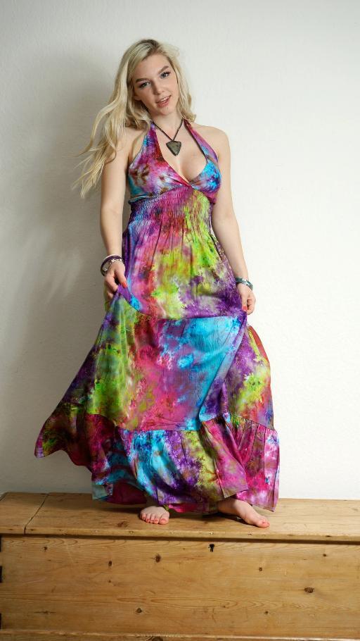 Picture of a womens in a floor length dress in bright coloured fabric