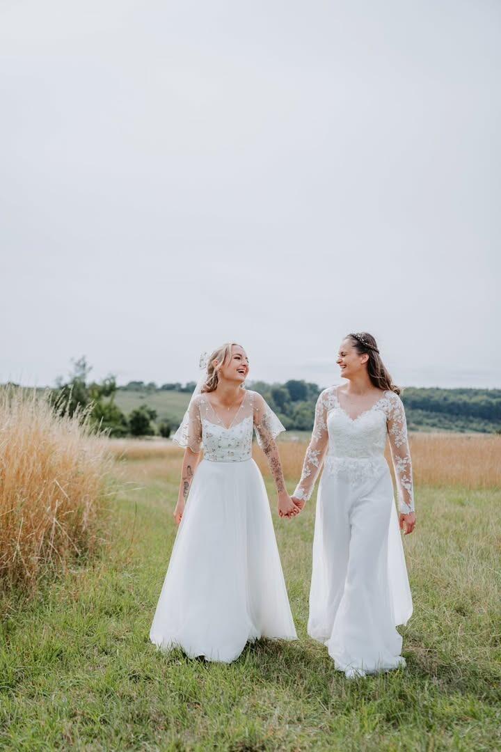 two beautiful real brides on their wedding day - one wearing the blossom wedding dress