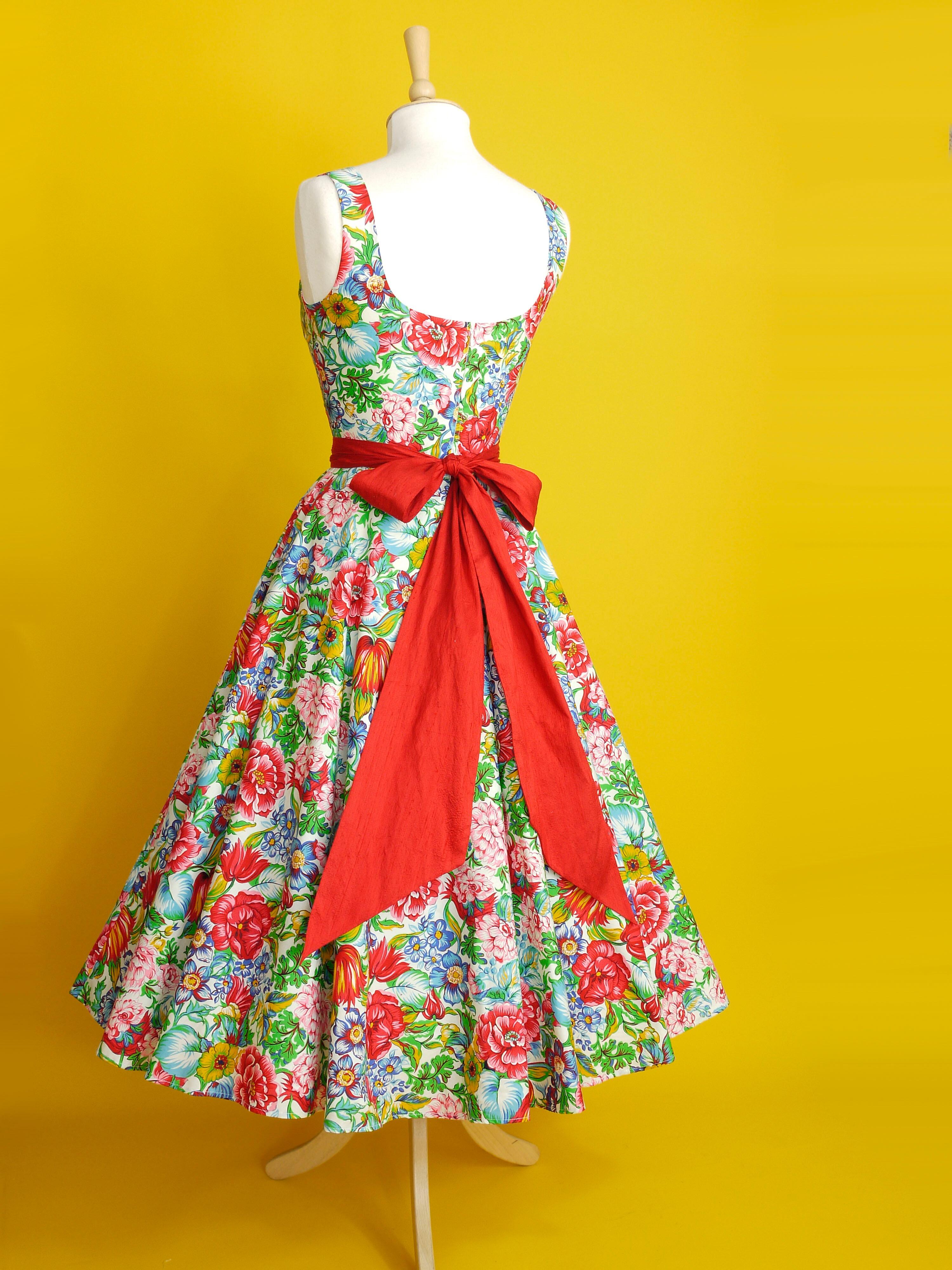 A multi coloured floral dress with a neatly fitted bodice and full skirt