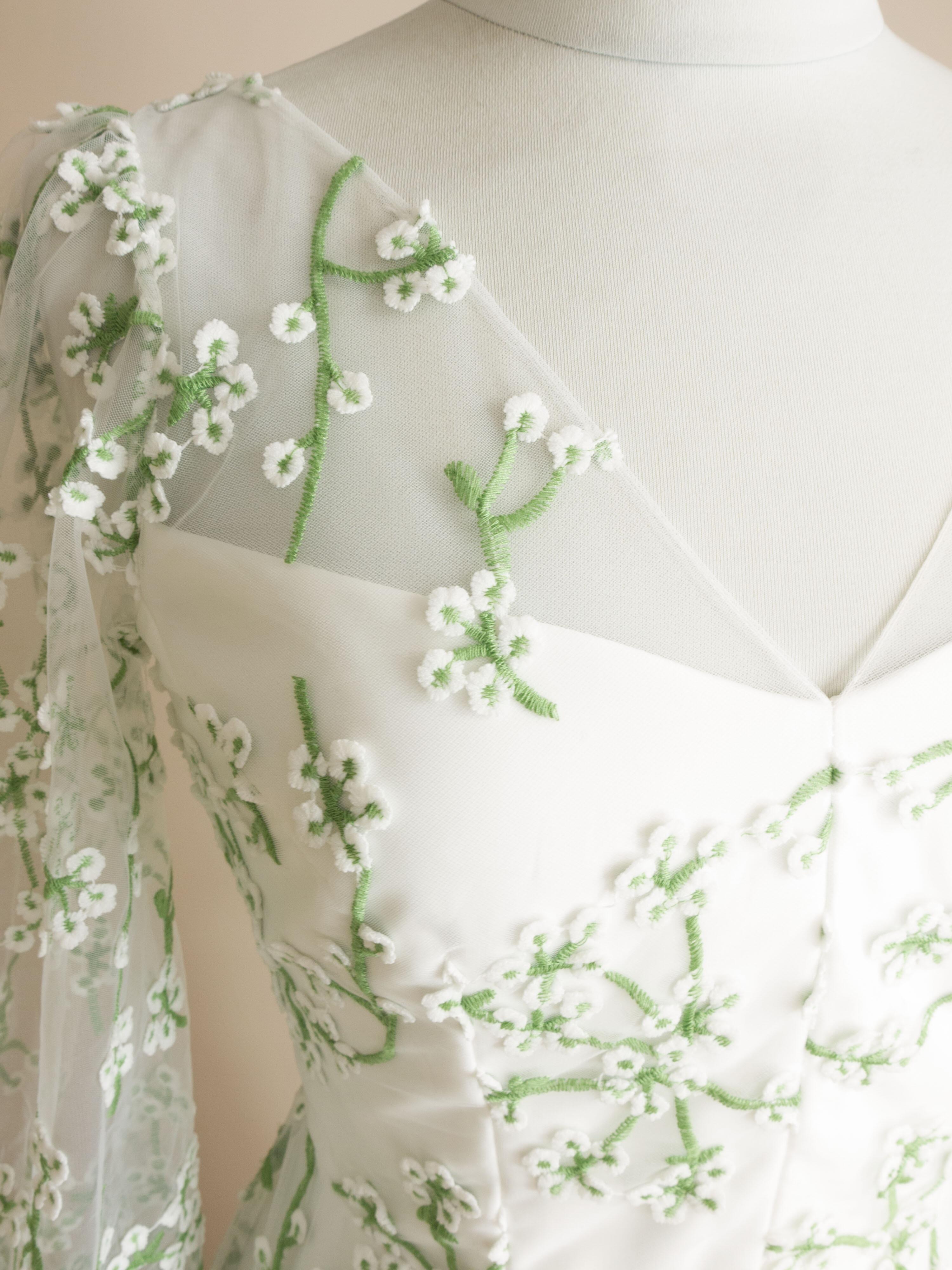 a close up detail of the green floral lace on the Jasmine wedding dress