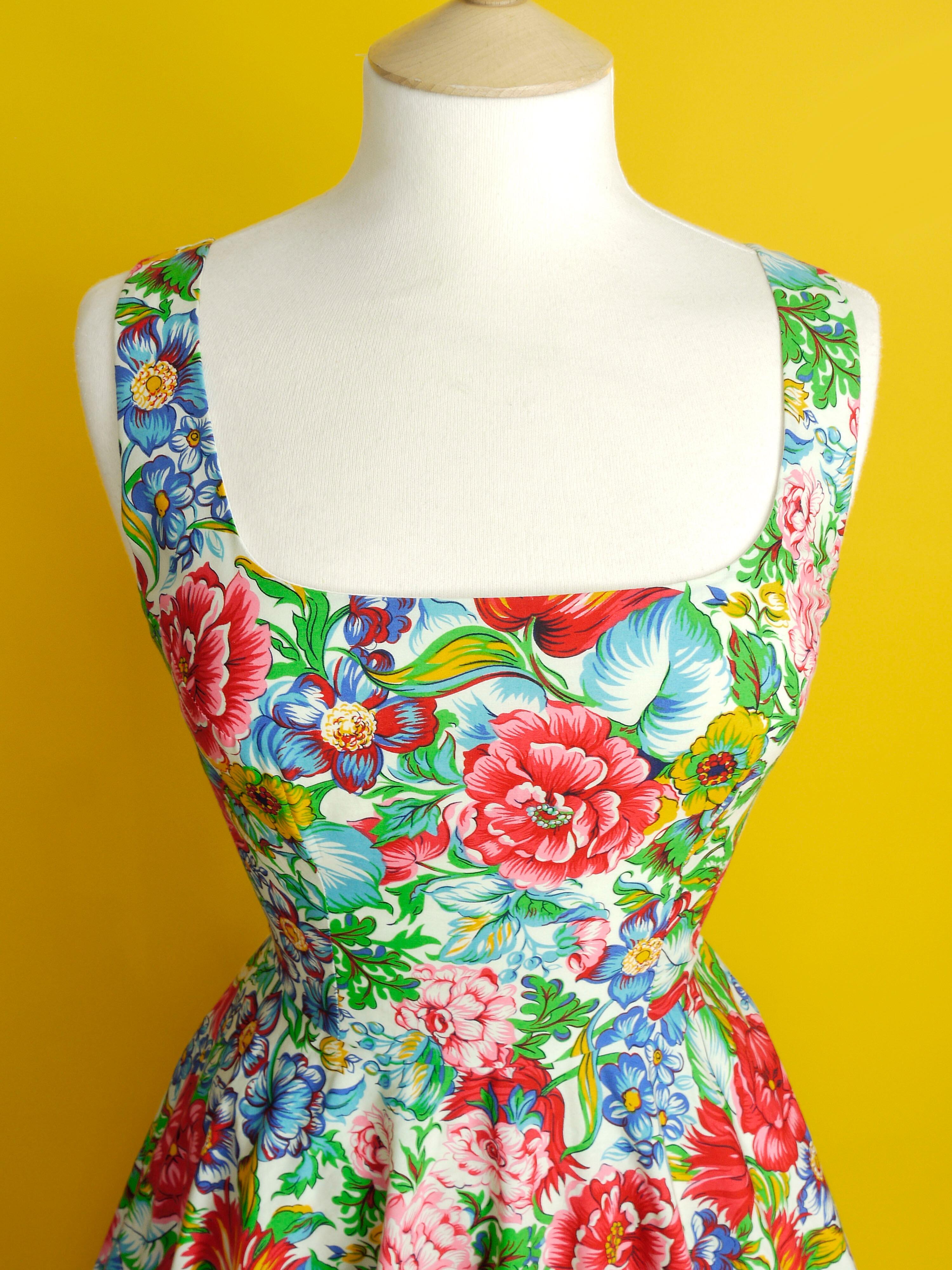 A multi coloured floral dress with a neatly fitted bodice and full skirt