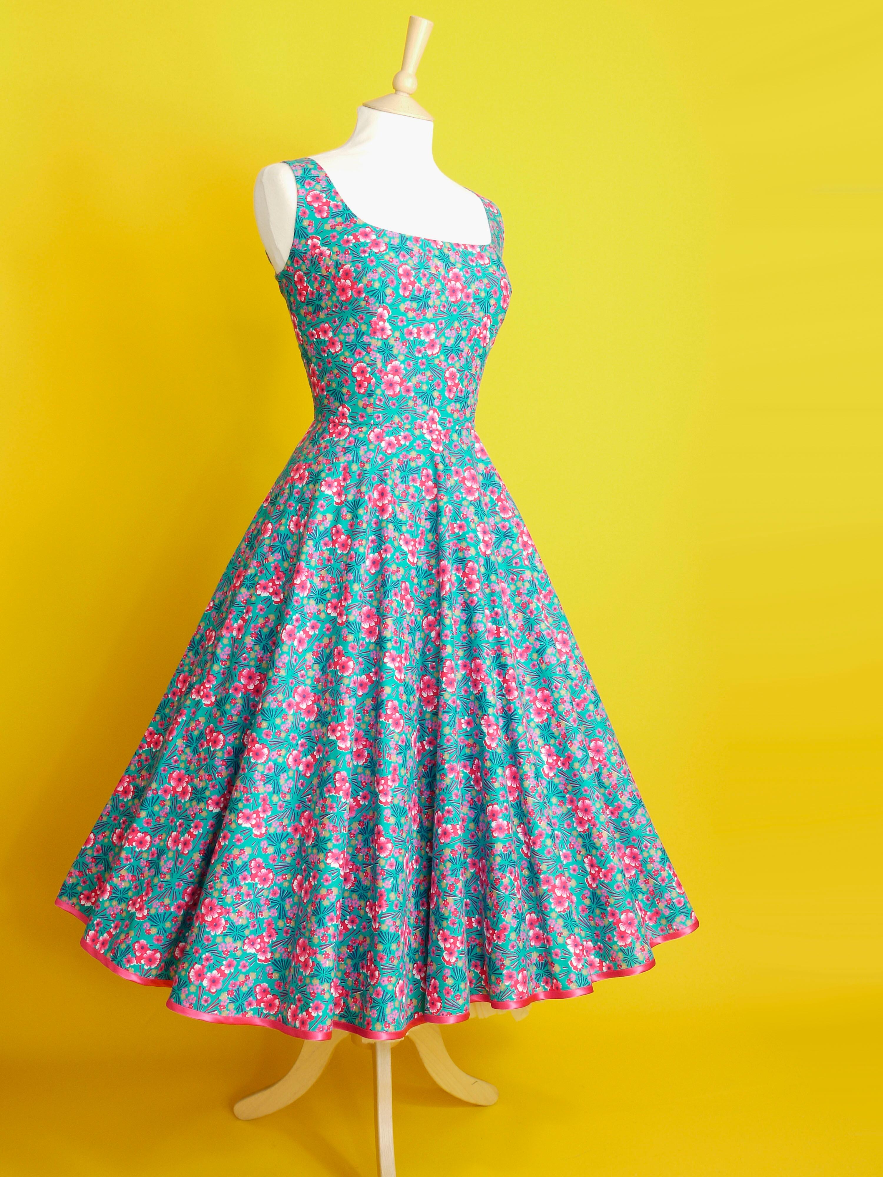 A 1950s style dress made in turquoise and bright pink patterned cotton fabric