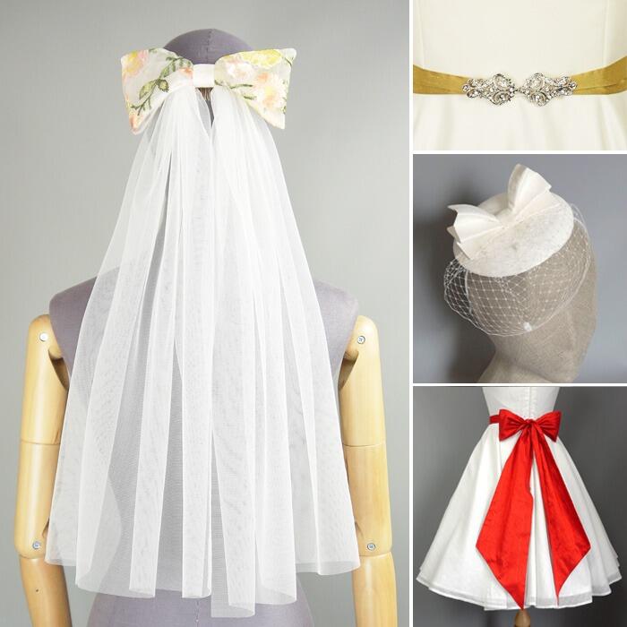 A collection of bridal accessories including an ivory veil with bow, a red silk sash and a vintage fascinator