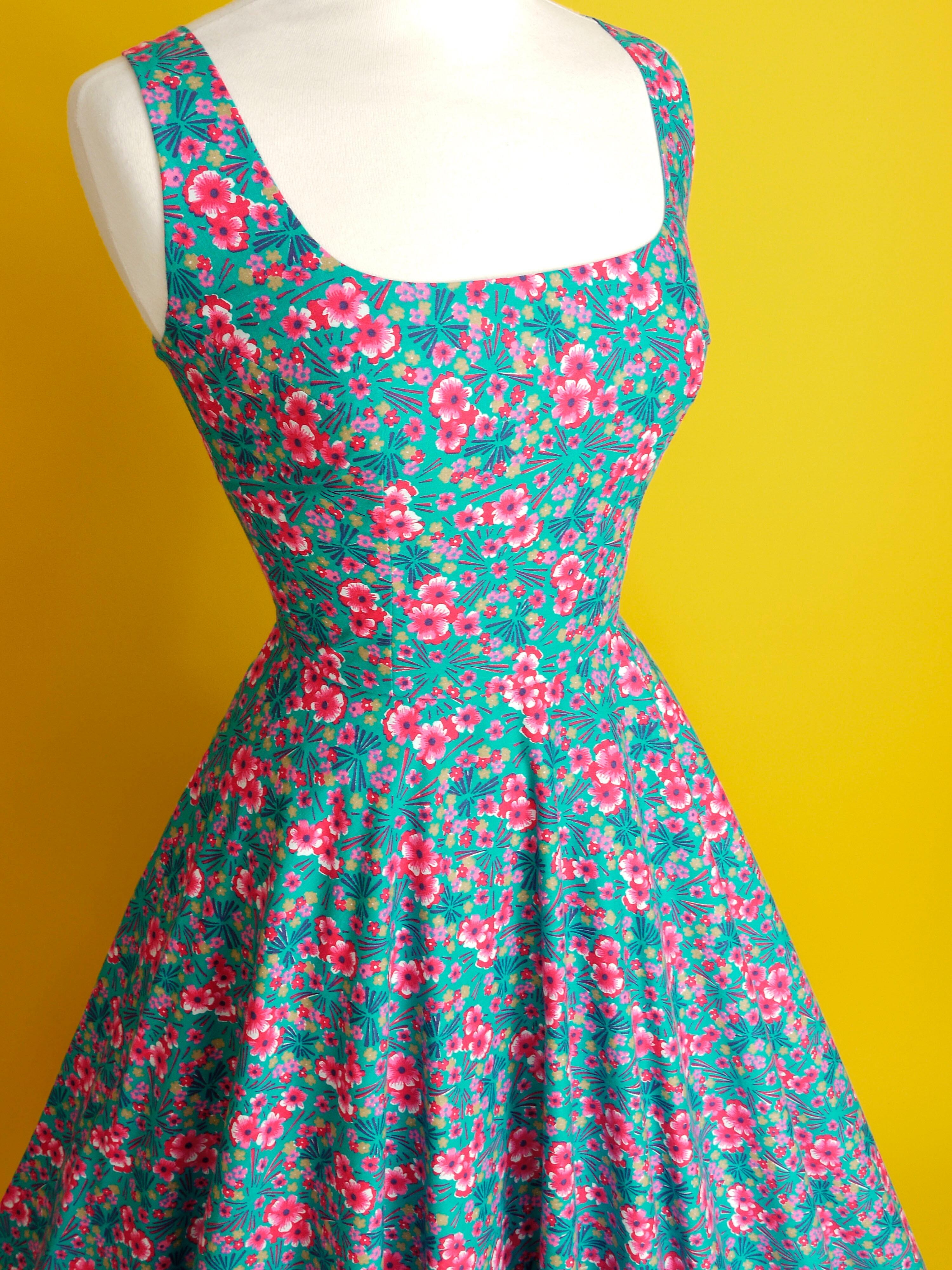 A 1950s style dress made in turquoise and bright pink patterned cotton fabric