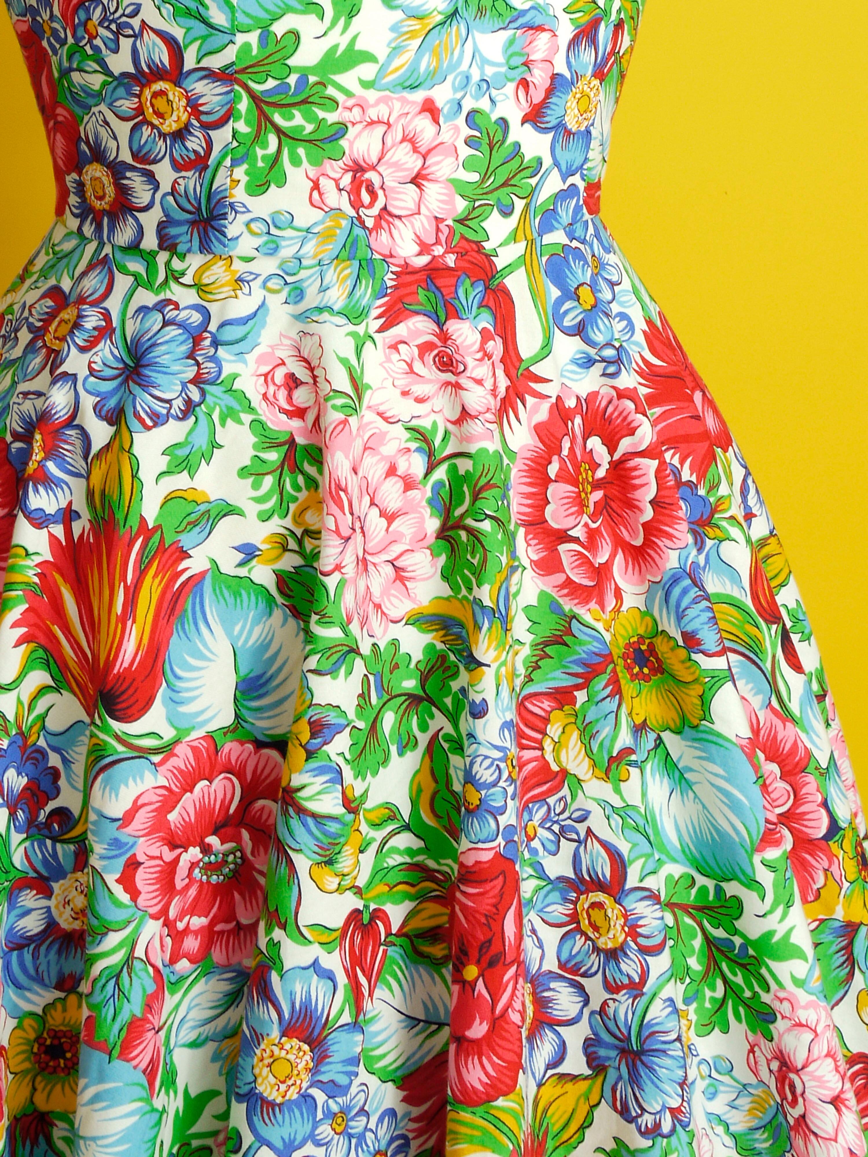 A multi coloured floral dress with a neatly fitted bodice and full skirt