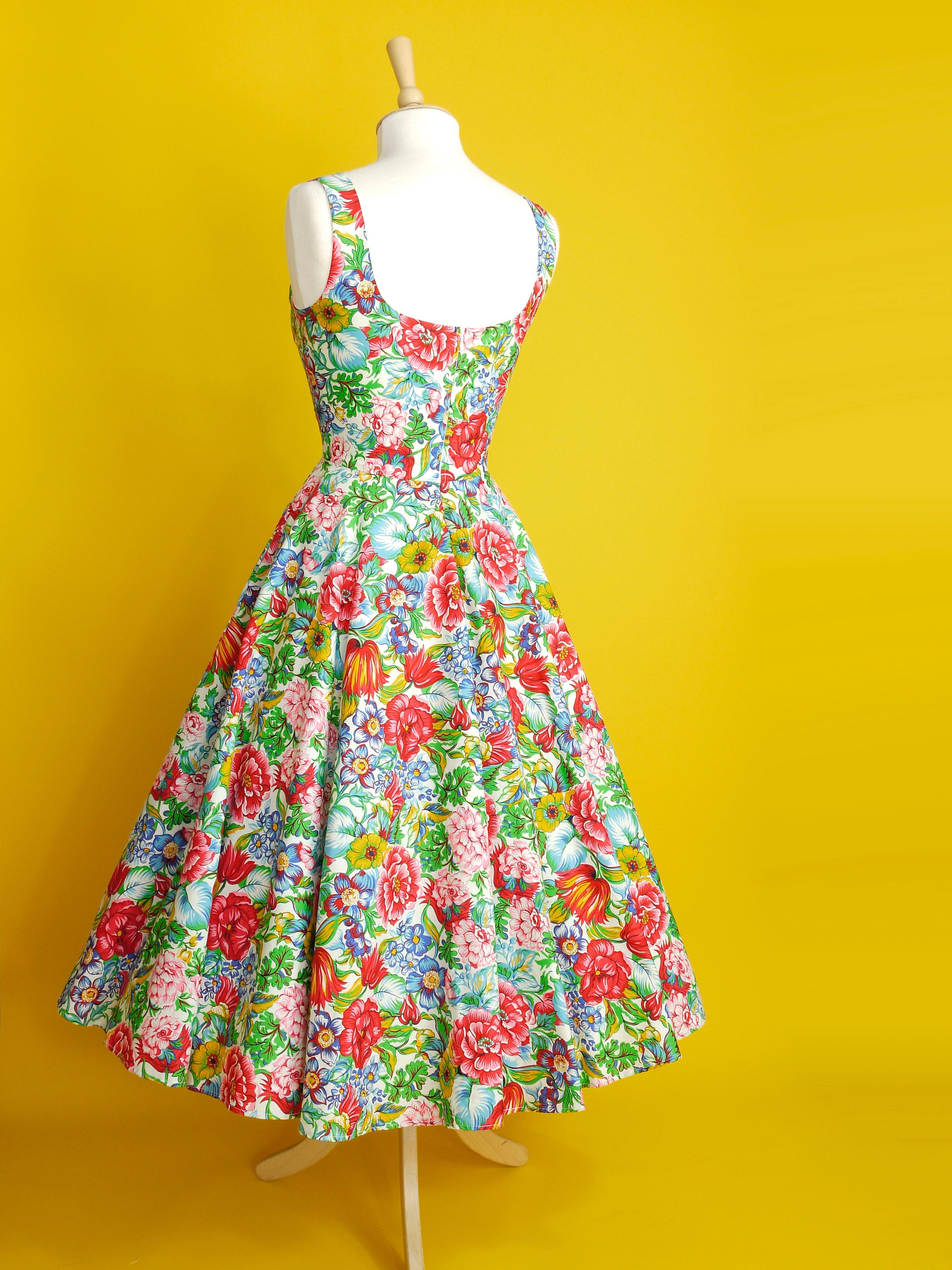 A multi coloured floral dress with a neatly fitted bodice and full skirt