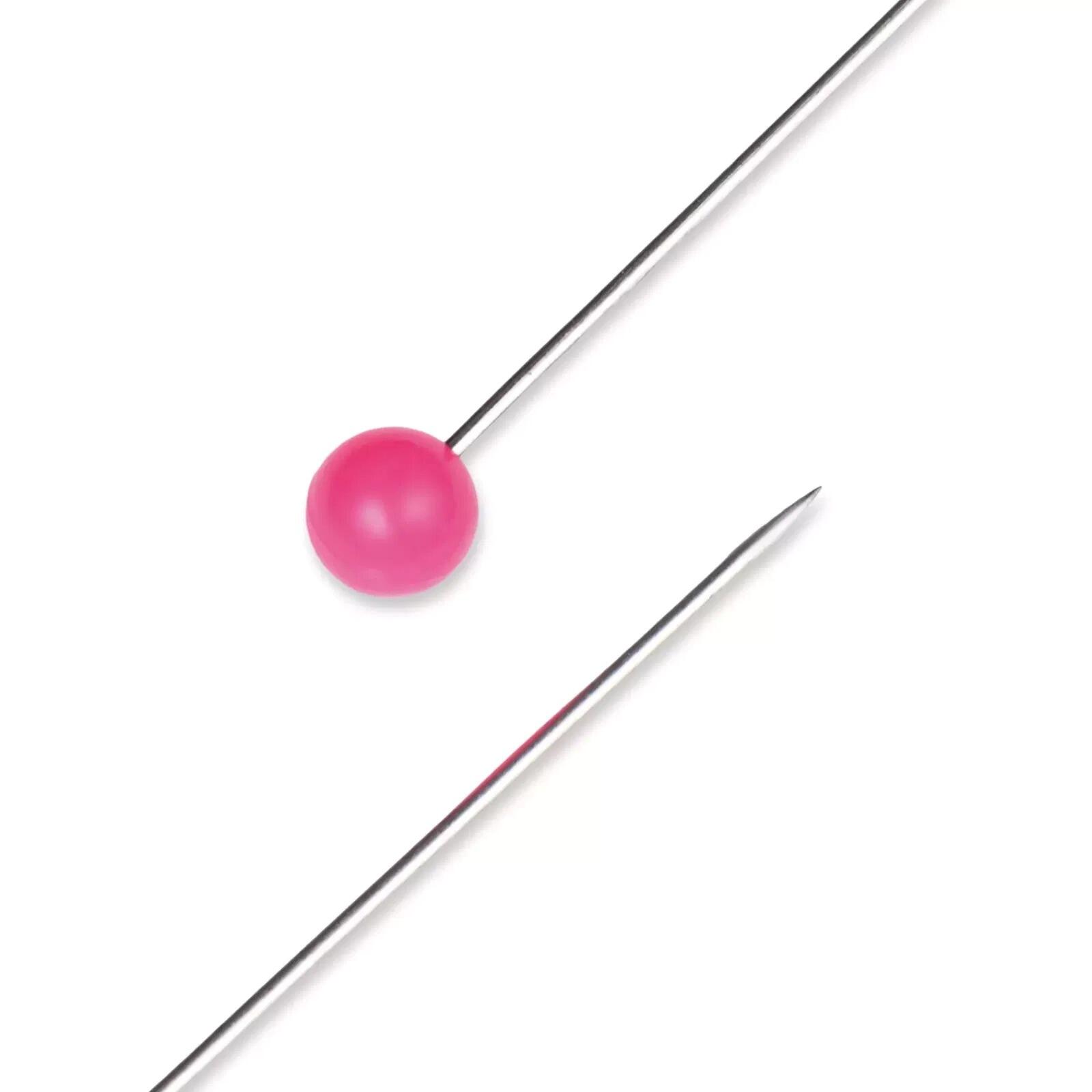 A close up look of a neon pink plastic headed pin made by Prym