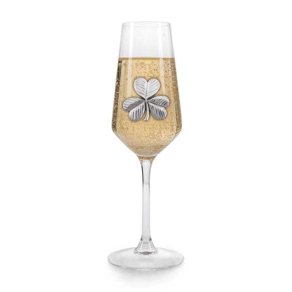 A Champagne Flute with a Pewter Shamrock badge on the front, filled with Champagne