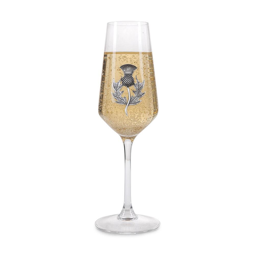 A Champagne Flute with a Pewter Thistle badge on the front, filled with Champagne