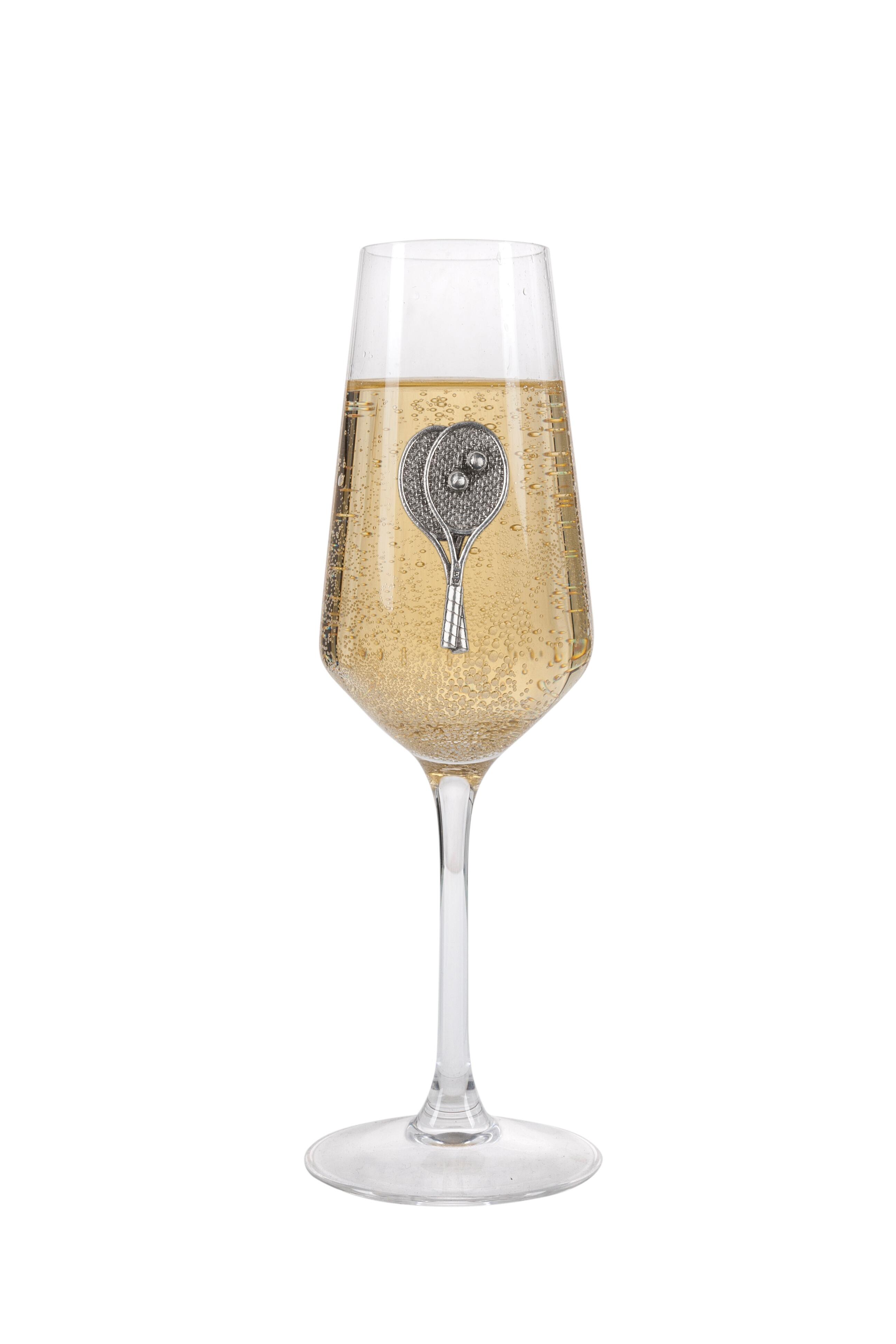 A Champagne Flute with a Pewter Tennis badge on the front, filled with Champagne