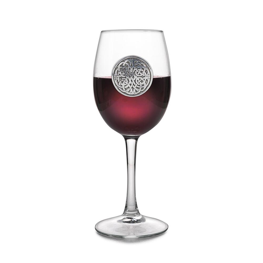 Wine glass with handmade pewter Celtic never ending knot badge filled with red wine