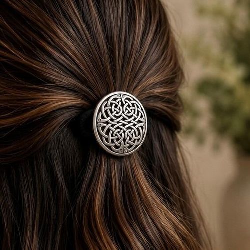 Round dome-style pewter Celtic hair bobble featuring an intricate, continuously interlaced zoomorphic knotwork design