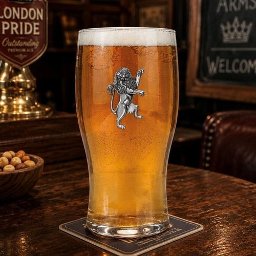 Pint glass with handmade pewter rampant lion with detailed mane in powerful heraldic stance badge filled with golden beer