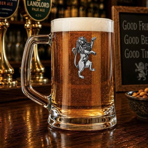 A Beer Tankard with a Pewter Rampant Lion badge on the front, filled with Amber Beer