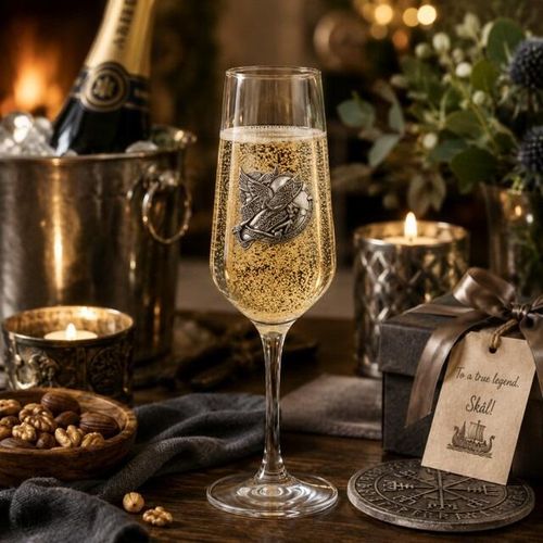 A Champagne Flute with a Pewter Viking badge on the front, filled with Champagne