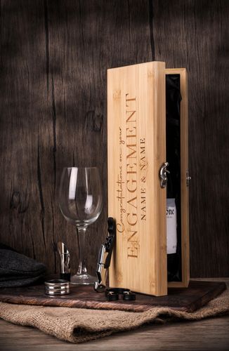 Personalised bamboo engagement wooden presentation box with luxury wine accessories and engraved names, displayed with wine glass and accessories