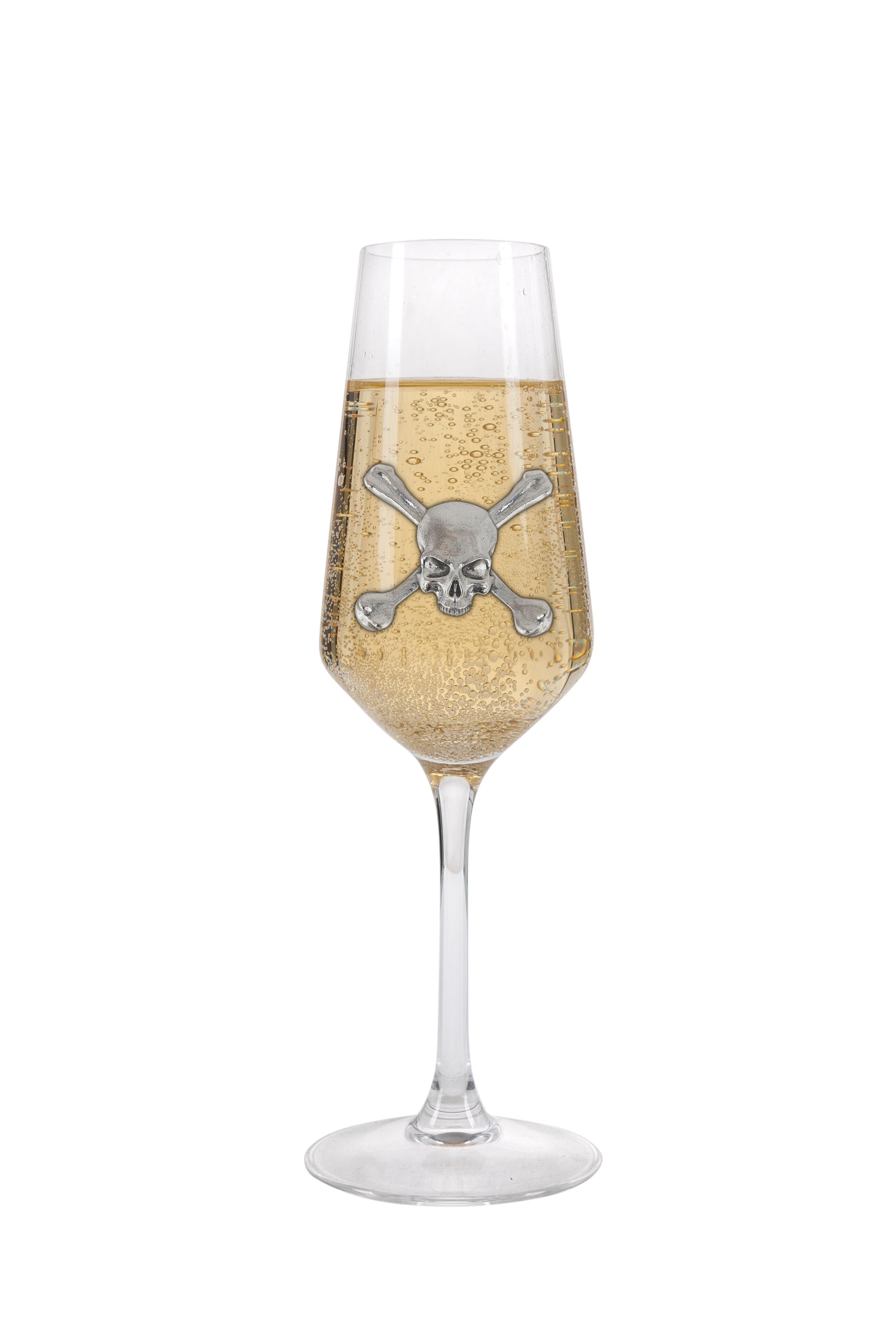 A Champagne Flute with a Pewter Skull badge on the front, filled with Champagne