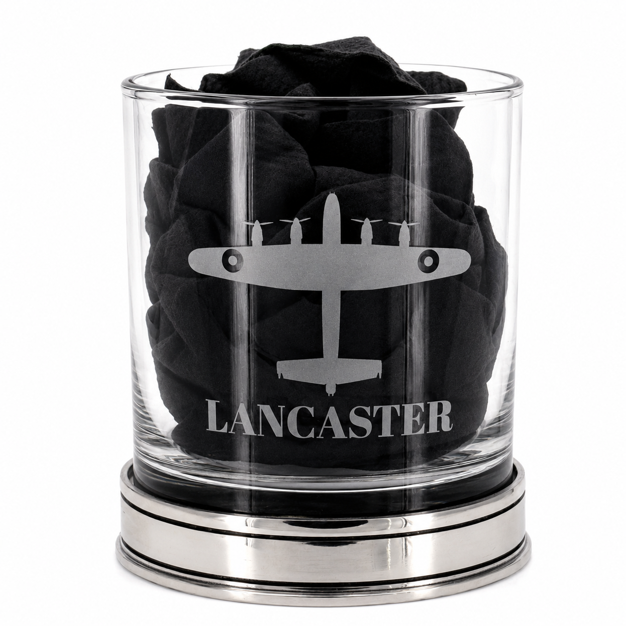 A whisky glass engraved with a lancaster bomber design with black tissue inside