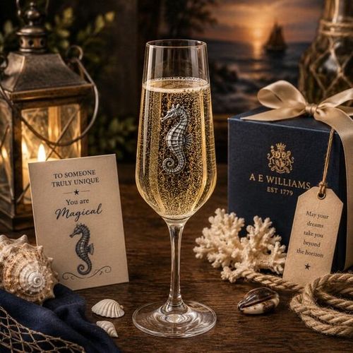 A Champagne Flute with a Pewter Seahorse badge on the front, filled with Champagne