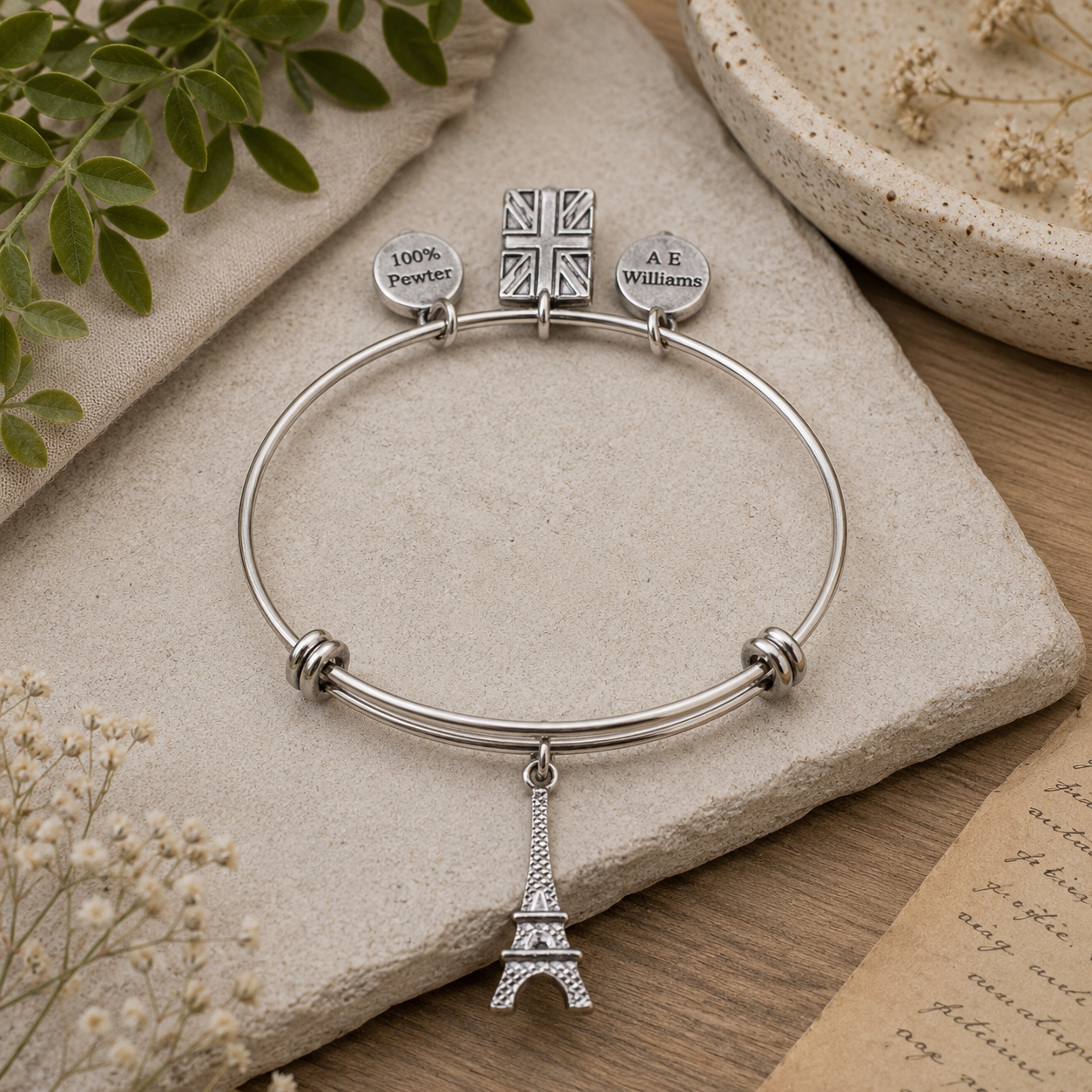 Eiffel Tower Pewter Charm on a soft stone background
