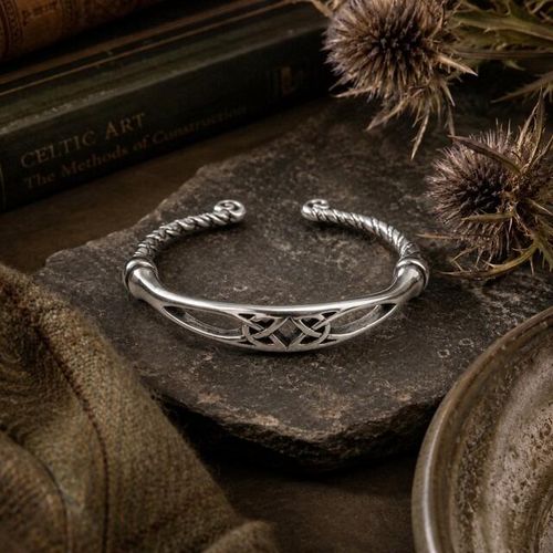Celtic knotwork pewter torc bangle with twisted band and scroll terminals