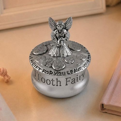 Round pewter tooth fairy box engraved with "Tooth Fairy," featuring a detailed fairy figurine on the lid surrounded by a patterned border
