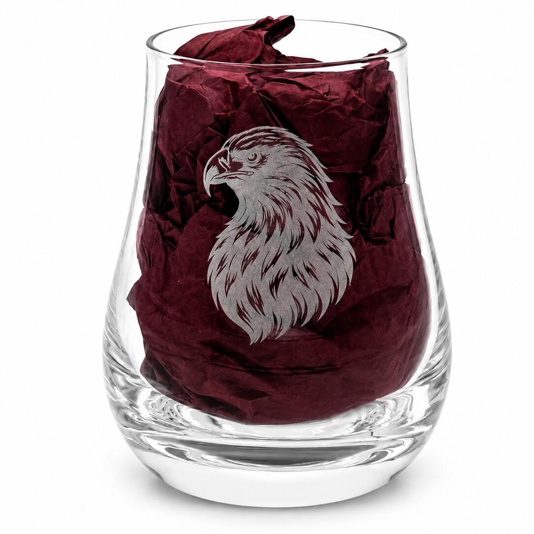 Close-up of eagle engraved whisky tasting glass with burgundy gift-box tissue