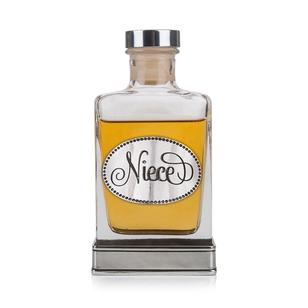 A glass flask with a pewter base and a handcrafted pewter “Niece” emblem on the front