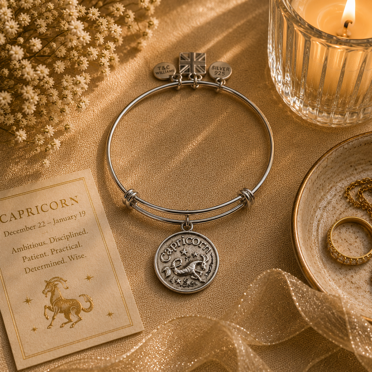 A Pewter Capricorn charm on a desk attached to an adjustable bracelet