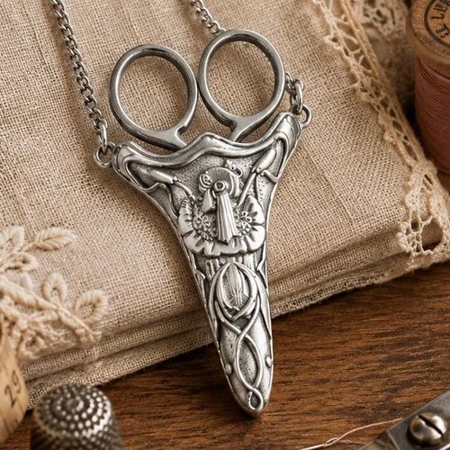 Vintage-style pewter Art Nouveau scissor chatelaine sheath featuring flowing floral relief designs on a silver-toned metal chain