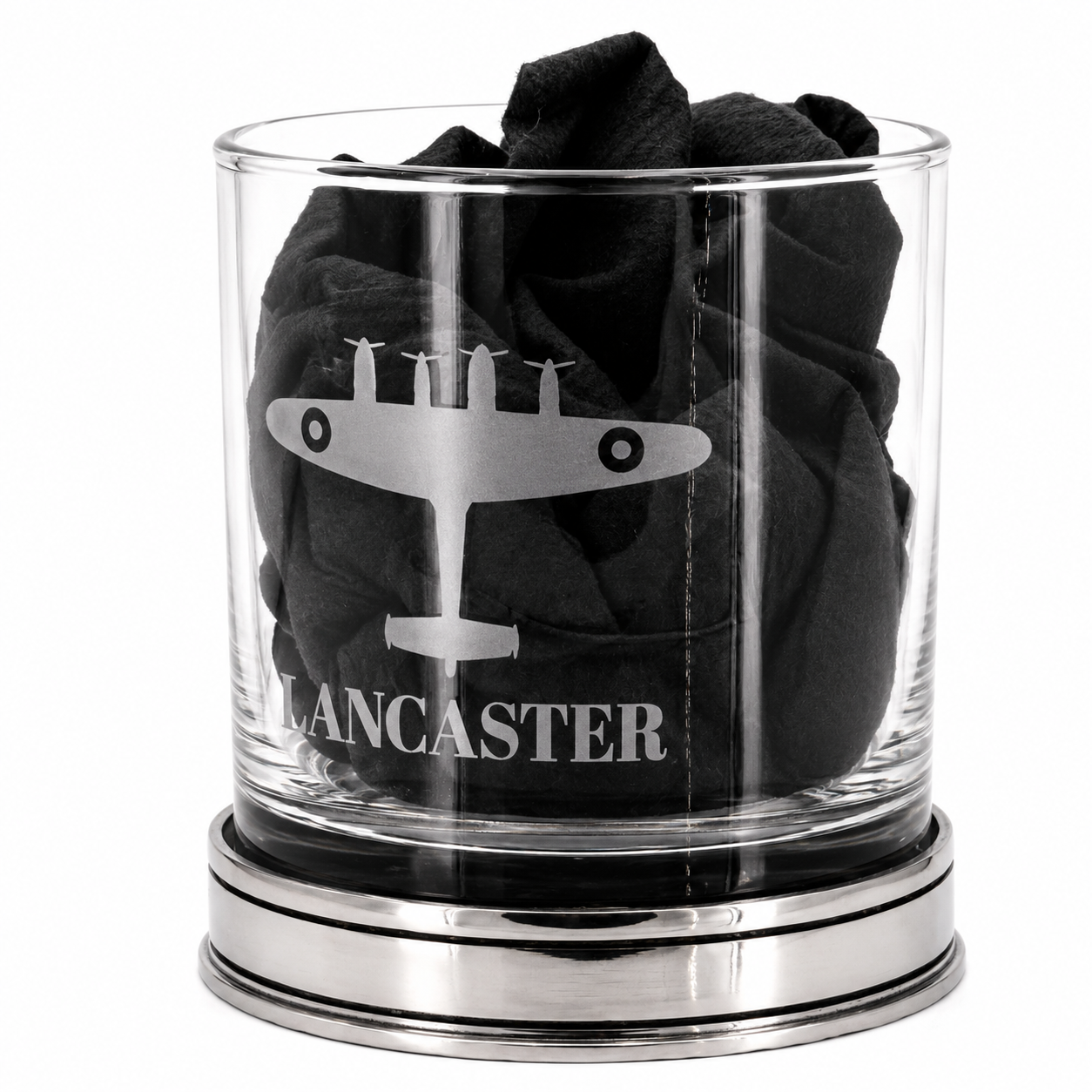 A whisky glass engraved with a lancaster bomber design with black tissue inside