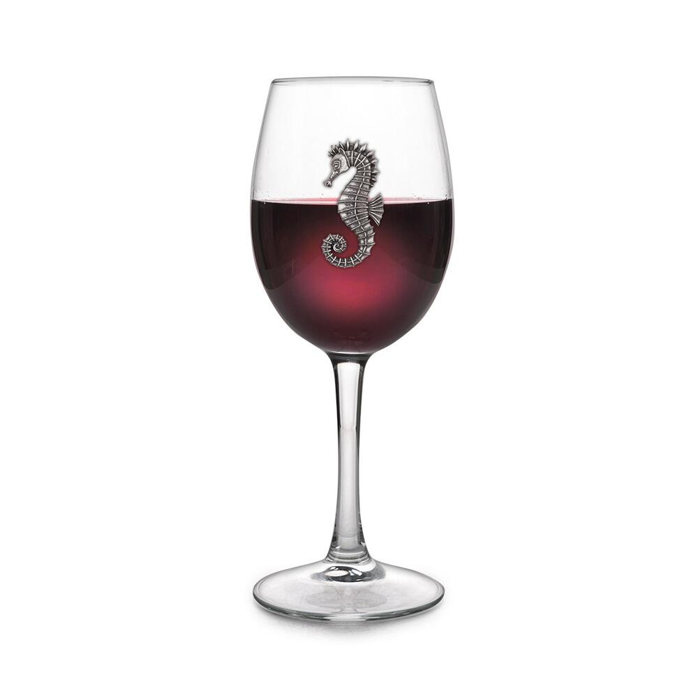 Wine glass with handmade pewter sea horse badge filled with red wine