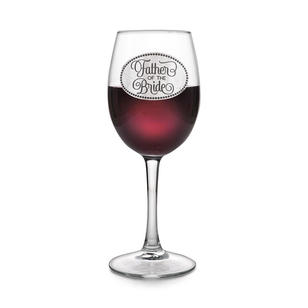 Wine glass with handcrafted pewter Father of the Bride badge filled with red wine