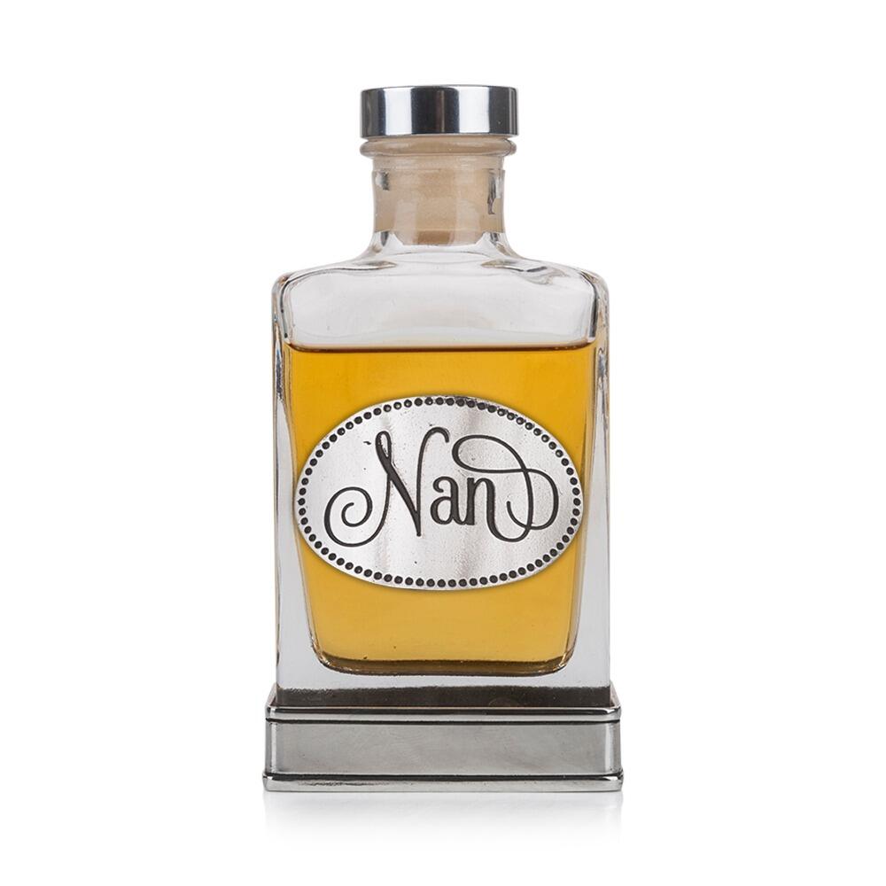 A glass flask with a pewter base and a handcrafted pewter “Nan” emblem on the front