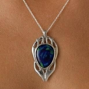 An Archibald Knox style pewter pendant featuring a polished Art Nouveau openwork top and a large oval central inlay of vibrant blue and green enamel