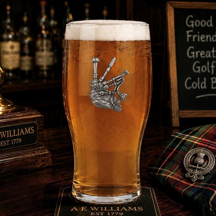 Pint glass with handmade pewter bagpipes with detailed tassels badge filled with golden beer