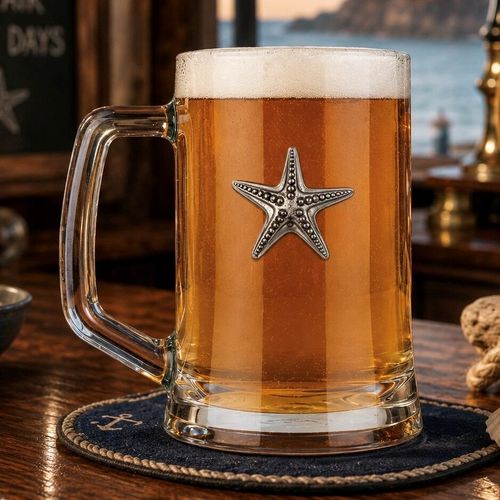 A Beer Tankard with a Pewter Starfish badge on the front, filled with Amber Beer