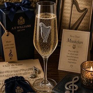 A Champagne Flute with a Pewter Harp badge on the front, filled with Champagne