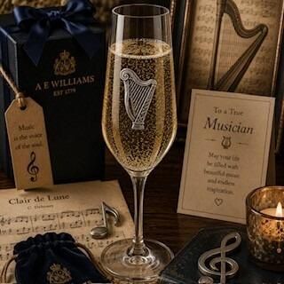A Champagne Flute with a Pewter Harp badge on the front, filled with Champagne