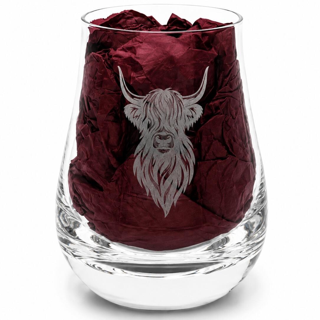 Close-up of Highland cow engraved whisky tasting glass with burgundy gift-box tissue