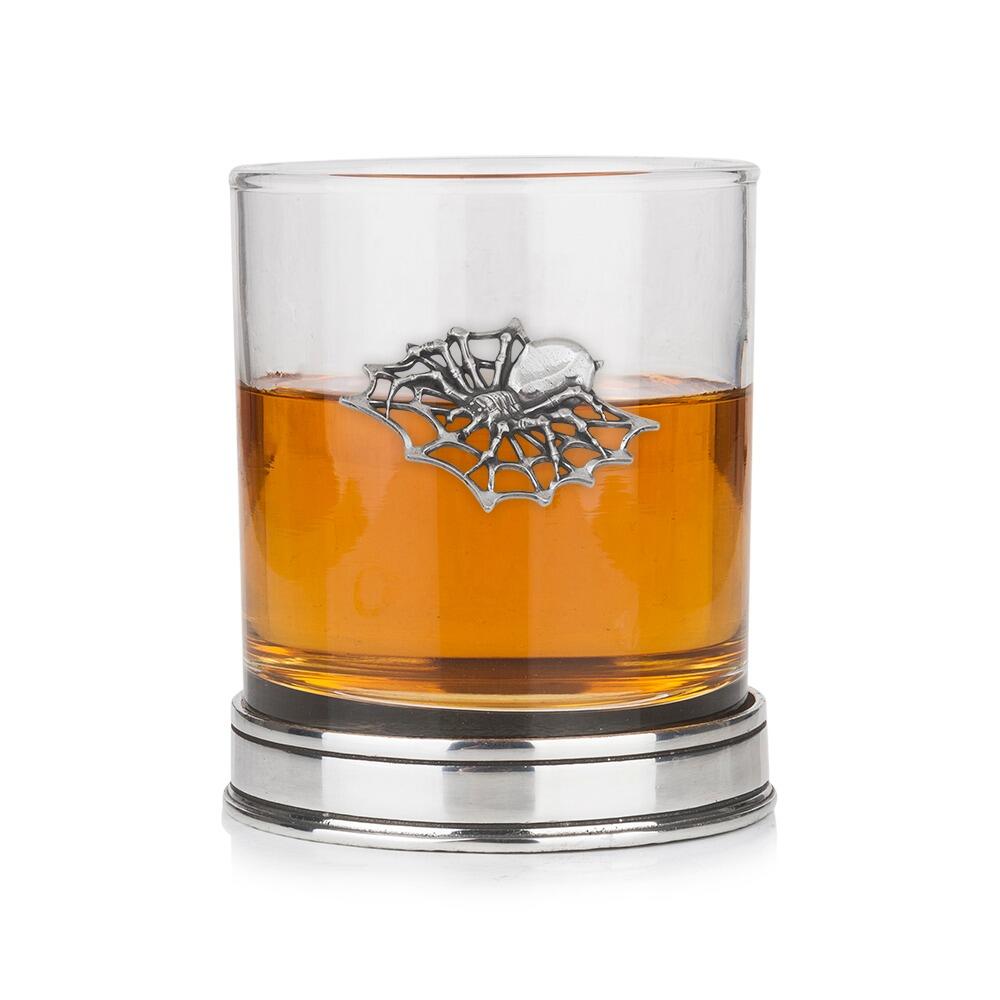 A Whisky Tumbler with a Pewter Spider badge on the front
