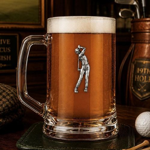 A Beer Tankard with a Pewter Golfing badge on the front, filled with Amber Beer