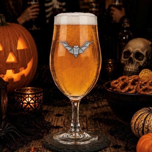 Premium stemmed beer glass featuring an intricate pewter bat motif, filled with amber al