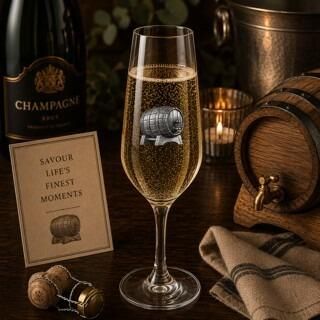 Crystal champagne flute with pewter champagne barrel emblem, filled with bubbly champagne