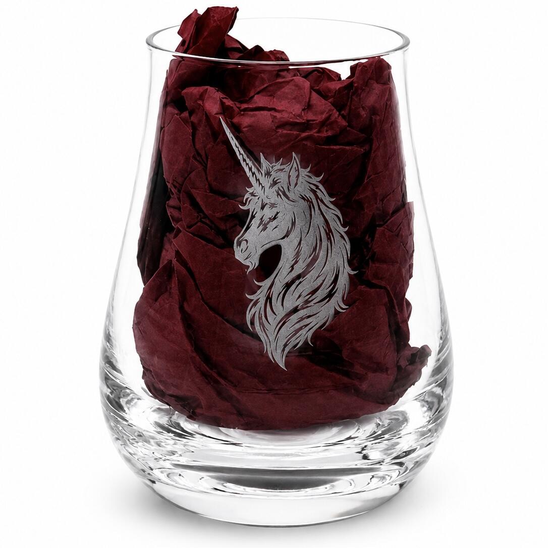 Close-up of unicorn engraved whisky tasting glass with burgundy gift-box tissue